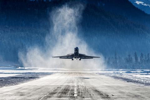 Business Jet departing a snowy airfield